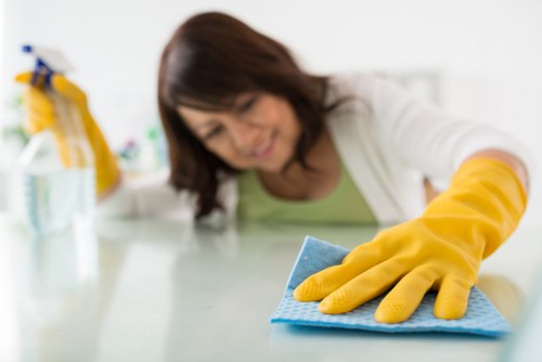 Technician treating stains during commercial carpet cleaning in Mitcham